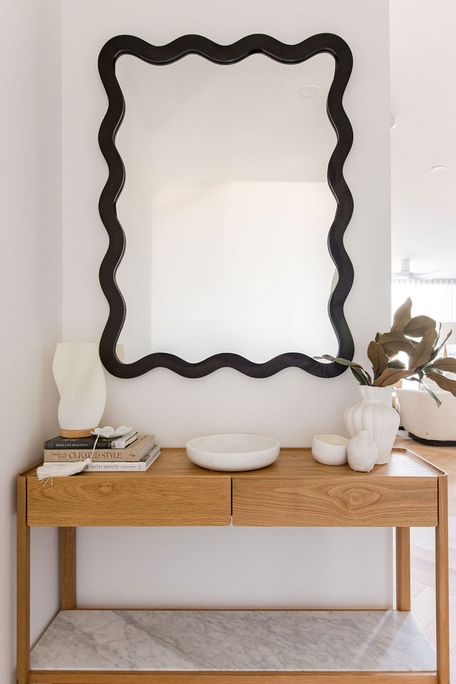 Entryway with statement mirror in contemporary style in New Farm Brisbane home.