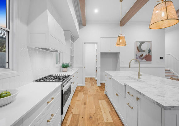 Hamptons style white kitchen with brass hardware by Brisbane Interior designer and decorator. 