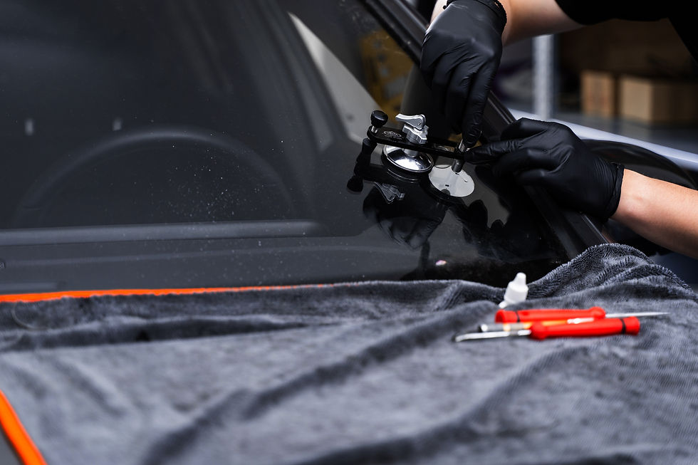 Windshield crack repair using resin injection Technician using windshield injector tool to