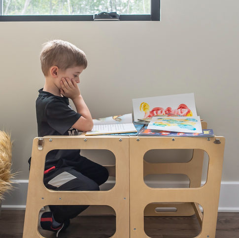 kid reading on desk educational tower