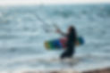woman-holding-kiteboard-and-going-into-the-water-2026-01-09-09-16-03-utc.jpg