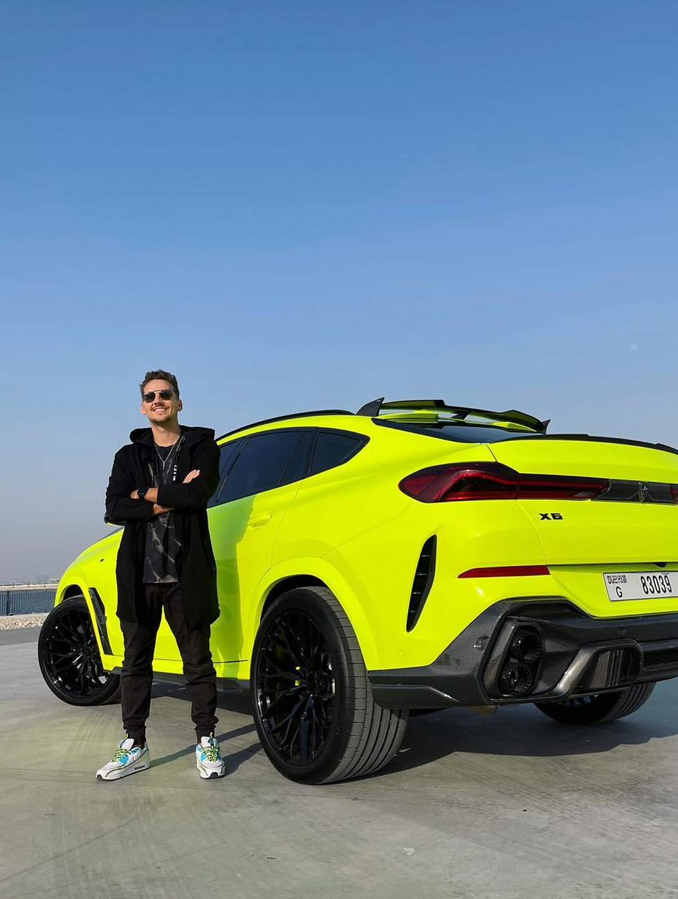 Sergi Galiano in front of a supercar - how much to charge for a brand deal under 10K followers