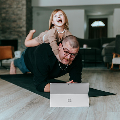 Small business owner trying to juggle childcare, exercise and running his business on his iPad