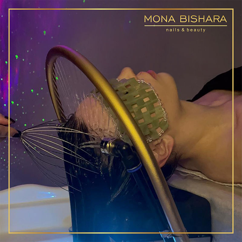 Woman receives a korean head spa treatment in a Mona Bishara nails & beauty salon.