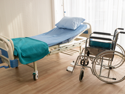 A photo of a hospital bed and wheelchair.
