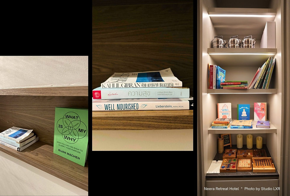 Books and games on wooden shelves in a well-lit room. Titles include "Well Nourished," "What is My Why," and "Kahlil Gibran." Candles below.
