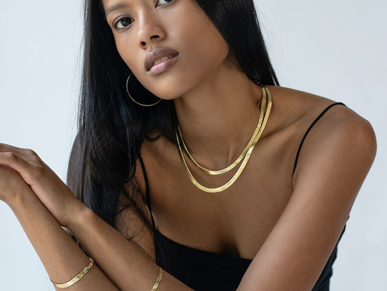 A jewelry model in a high end on-model product photogrpahy studio set