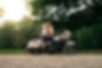 Newly engaged couple kissing on motorcycle during engagment portrait session.