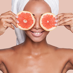 girl holding grapefruit slices