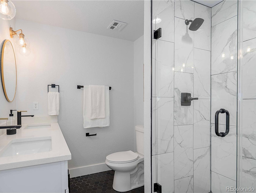 Modern white bathroom remodeling services Denver features.