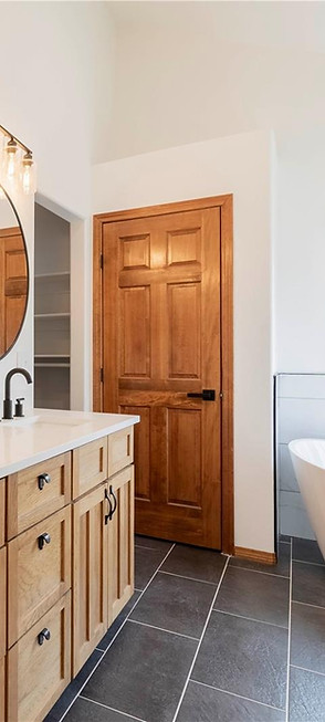 Modern full bathroom remodel with double vanity and tub.