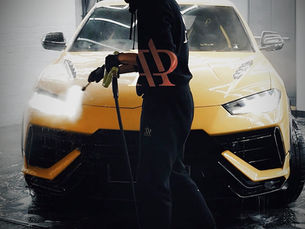 Man washing a yellow Lamborghini, exterior wash and detailing