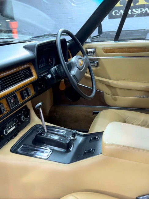 interior of the Vintage Jaguar XJS yellow leather colour seats in the detailing shop Chelsea London