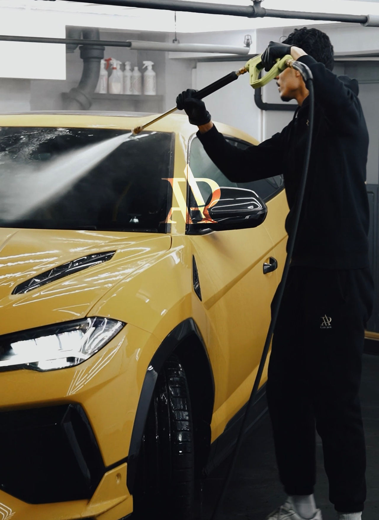 Man washing a yellow Lamborghini and detailing