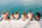 Family sitting on the edge of The Mowana trimaran ready to snorkel in the crystal-clear waters of Guanacaste, Costa Rica — Mowana Sailing