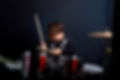 Cheerful smiling child plays the drums. Boys Studios..jpg