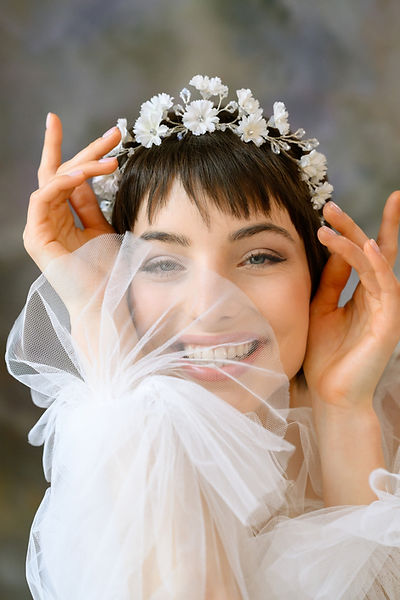 Introducing our organic tiara, adorned with silver-plated branches, exquisite opal Swarovski crystals, and delicately hand-painted blooms. This design effortlessly complements both understated silk gowns and stunning lace dresses, embodying a regal yet natural and organic charm, featuring small carnation flowers. For a more dramatic effect, pair it with our cascading carnation earrings and make a unique statement that captures the essence of elegance.