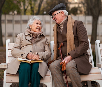 happy-senior-friends-on-sitting-on-bench