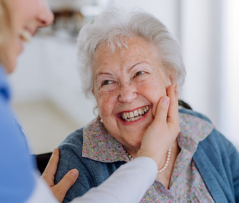 close-up-of-nurse-stroking-cheek-of-seni