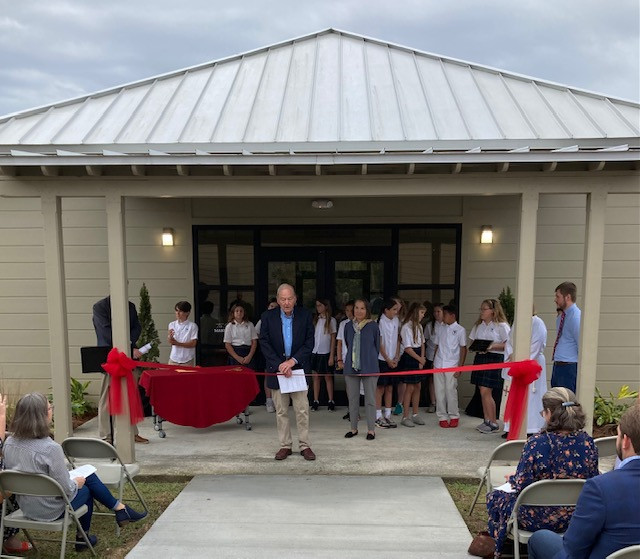 Bill and Wynn Seemann, Donors, cut the ceremonial ribbon with golden scissors created in the Seemann Makerspace of the Coast Episcopal School at the November 18 Dedication