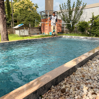 Technician performing a swimming pool service visit