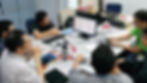 Micron semiconductor team members collaborating around a table on a VSM project charter during a Value Stream Mapping workshop facilitated by Operational Excellence Consulting Singapore