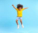 Full length of energetic little ethnic boy with Afro hairstyle in stylish casual outfit ju