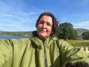 A human freelance copywriter photographed in the wild on the shores of Lake Ullswater.