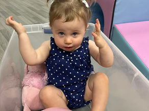 Toddler playing inside a box