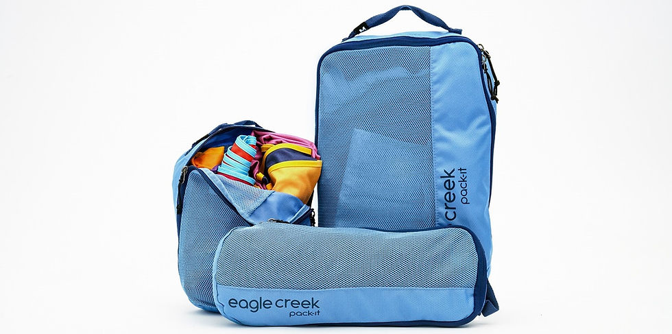 Eagle Creek Pack-It packing cube set in blue with colorful clothes packed inside.