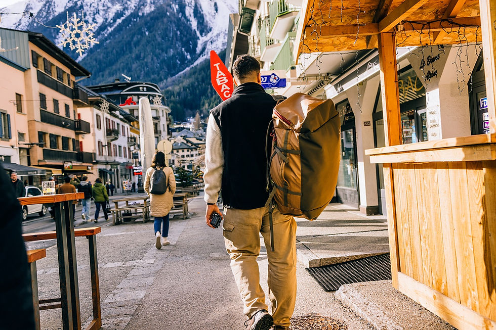 Person wearing Eagle Creek Cargo Hauler backpack walking through snowy Chamonix village street.