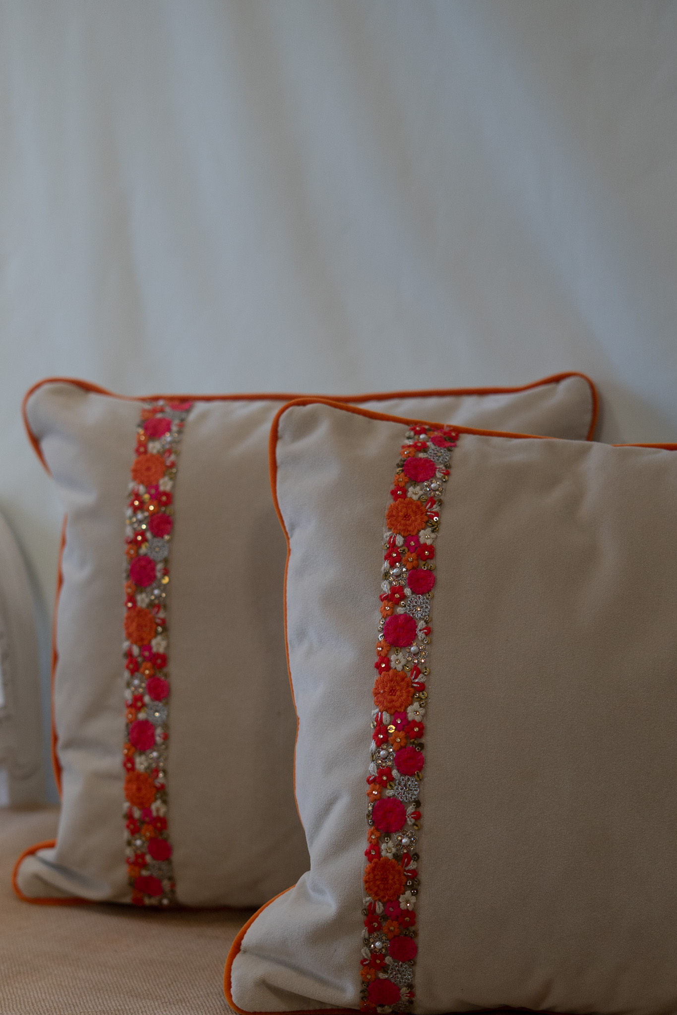 Cream Cushions with Orange Trim and Sequin Detailing