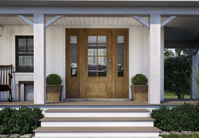 Image of a front porch of a white house with brown door and trim.