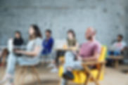A group of adult students sittng and listening to a lecture
