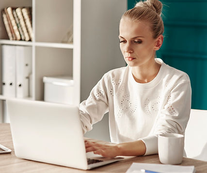 serious-woman-with-laptop-working-home-office.jpg