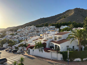 White Andalusian houses in San Juan de Capistrano with mountains in the background