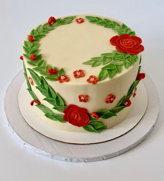 Palette knife flower cake.  White cake, single tier with rose color them and greenery.