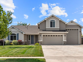Multi-generational home in NE Nampa, Idaho featuring a modern kitchen, spacious living areas, guest suite, RV garage, and large backyard.