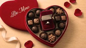 Diamond engagement ring in a velvet box inside a heart-shaped box of chocolates, symbolizing a Valentine's Day proposal near Piqua and Troy, Ohio.