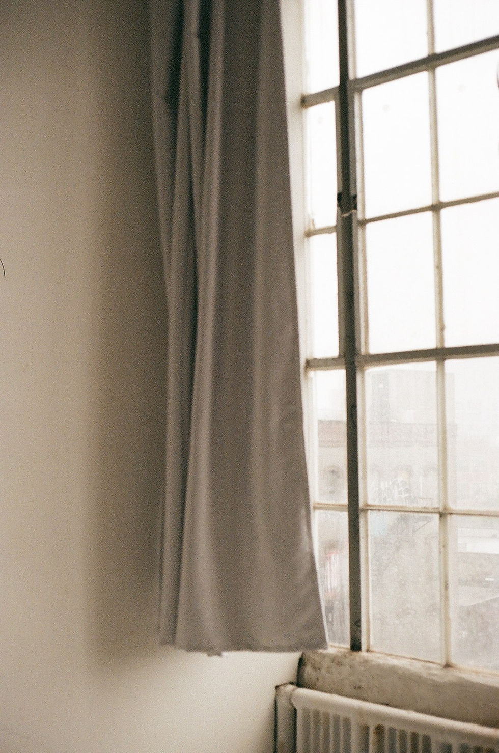 Soft daylight through a window with neutral curtains