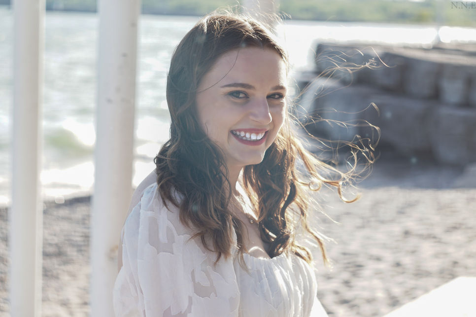 Photograph of bride smiling at the beach