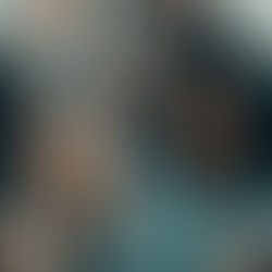 A group of people smiling and laughing together in a warm, joyful moment.