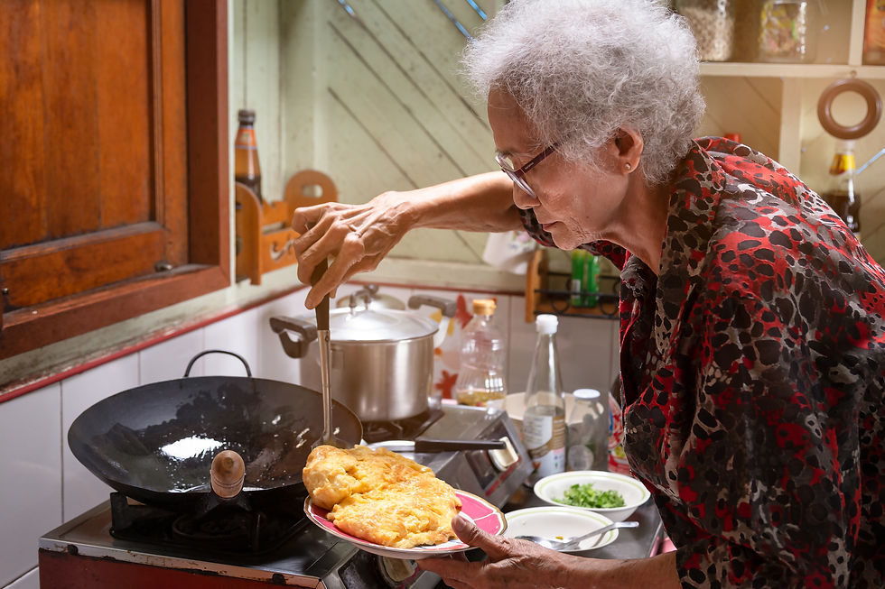Senior asian woman cooking omelet in kitchen at home,lifestyle of asian old woman concept.