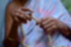 Elderly hindu religious indian woman praying to God using a rosary beads