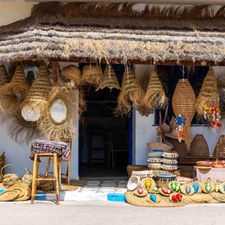 Handmade baskets displayed outside a traditional craft workshop in Tunisia.