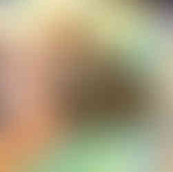 Woman resting on a beach towel in Tunisia with a hat covering her face