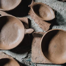 Hand-formed Sejnane ceramic bowls and vessels before firing in open kiln