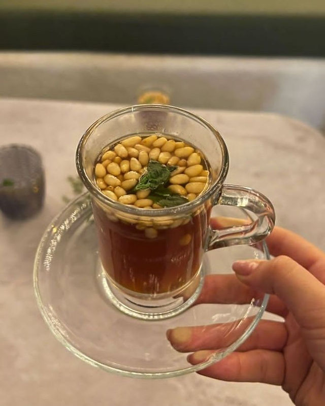 Tunisian green tea with mint and pine nuts served in a glass