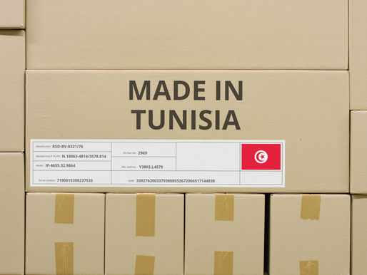 Cardboard boxes stacked together, one labeled “Made in Tunisia” with the Tunisian flag and product codes.