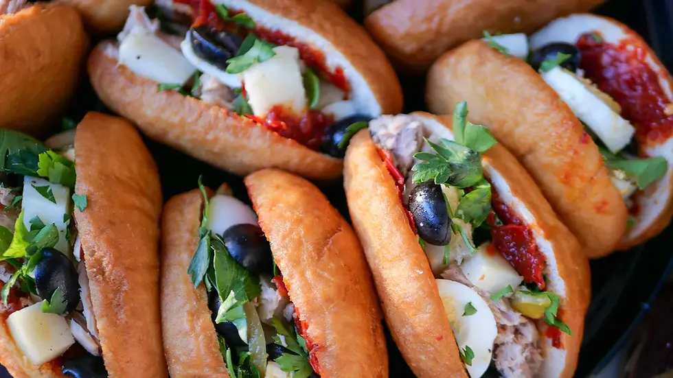 Fricassé Tunisian sandwiches made with fried dough, filled with tuna, egg, olives, and harissa